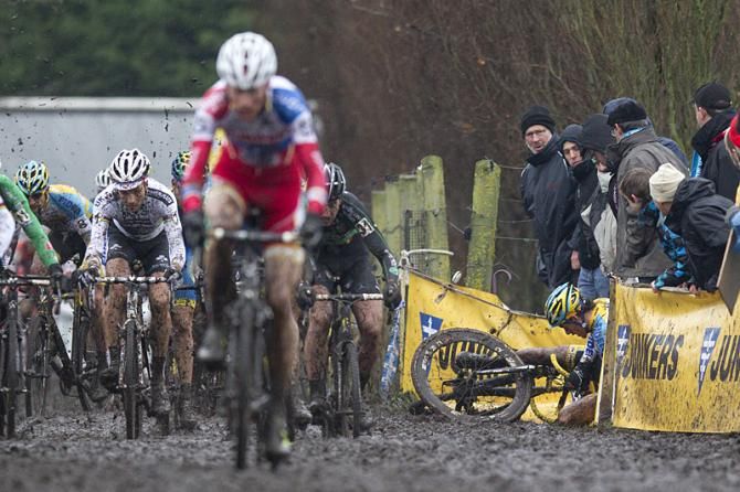 Vantornout in the front as a rider goes down through the barriers