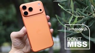 Cosmic Orange iPhone 17 Pro held in a hand.