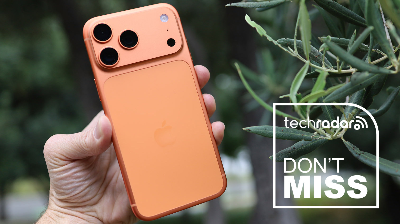 Cosmic Orange iPhone 17 Pro held in a hand. 