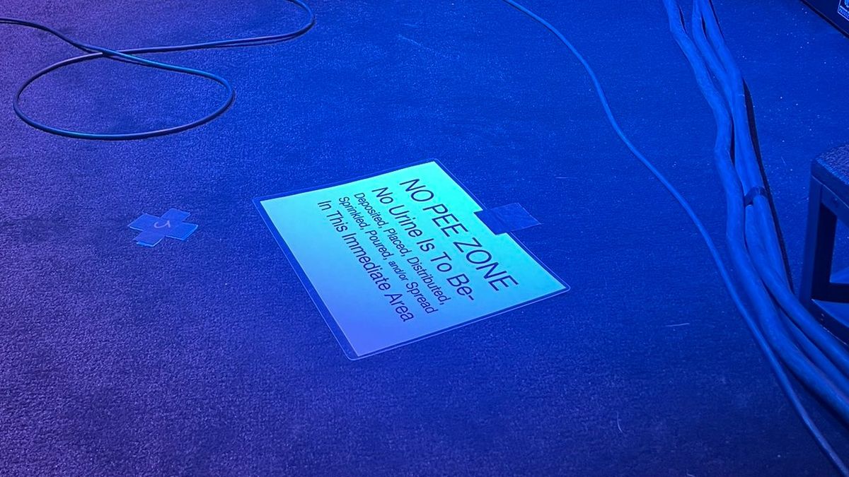 A No Pee Zone sign on stage at Tool