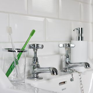 bathroom with white tiles and tap