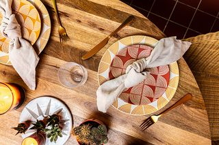 Dining table with patterned cutlery and playtes