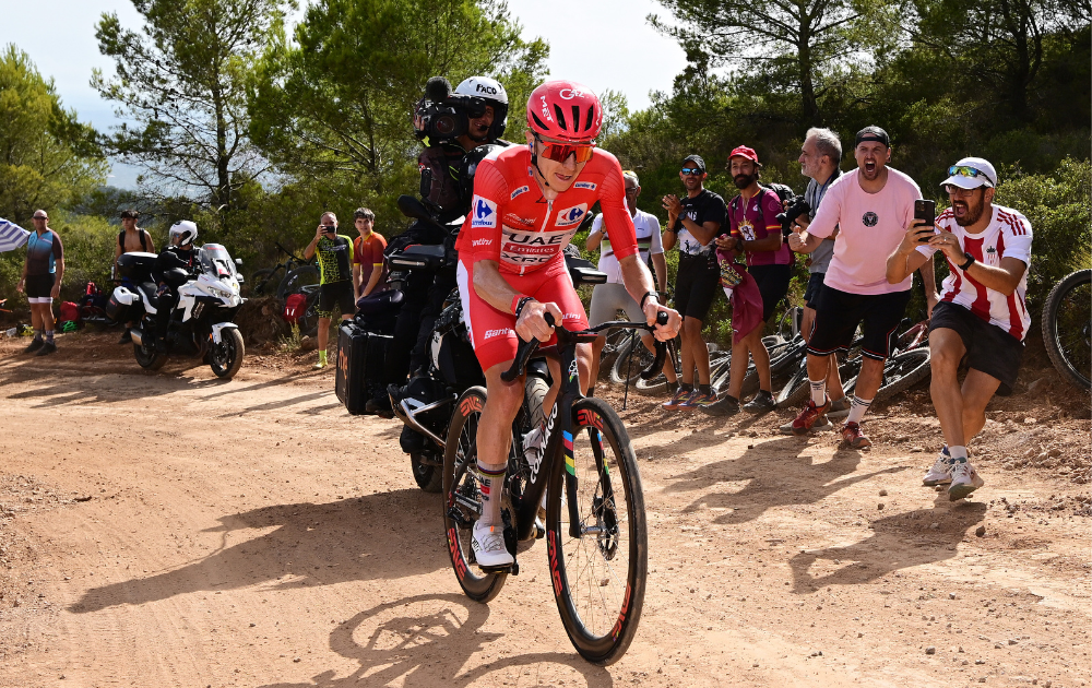 Stage winner Tadej Pogacar of Slovenia and UAE Team Emirates XRG - Red Leader Jersey competes in the breakaway passing through the Puerto El Bartolo gravel strokes sector during the La Vuelta