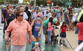 Spectators pack the sidewalk near Space View Park in Titusville, Fla., on Wednesday, May 27, 2020.