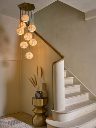 A pendant light fixture hanging alongside a staircase