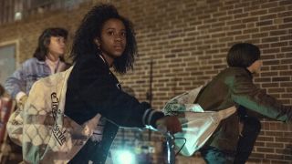 Tiffany Quilkin has a concerned look on her face as she sits on her push bike in Paper Girls, one of the best Prime Video shows.