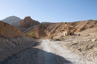 The entrance to the West Valley of the Valley of the Kings is seen here. in the West Valley, archaeologists are excavating what may be the tomb of Tut's wife. The house of Theodore Davis (1838-1915), a wealthy man who explored the Valley of the Kings, can