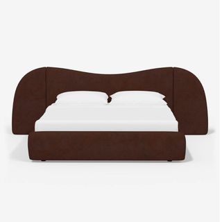 A bed with a wavy headboard