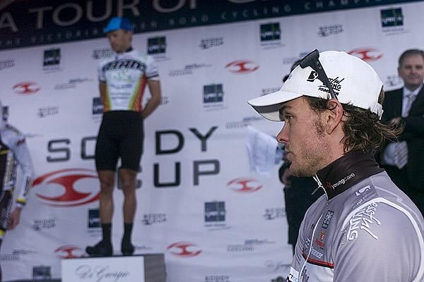 David Kemp (Fly V Australia) awaits his call up to the podium after some argy-bargy in the dash to the finish had commissaires on their toes.
