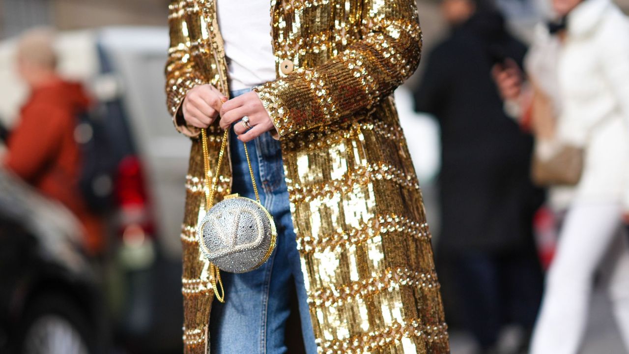 Fashion week attendee wearing sparkly jacket, sparkly Valentino bag and sparkly nails