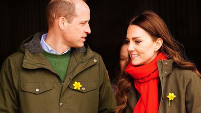 Britain's Prince William, Duke of Cambridge, and Britain's Catherine, Duchess of Cambridge, react during their visit to Pant Farm, a goat farm that has been providing milk to a local cheese producer for nearly 20 years, near Abergavenny, south Wales