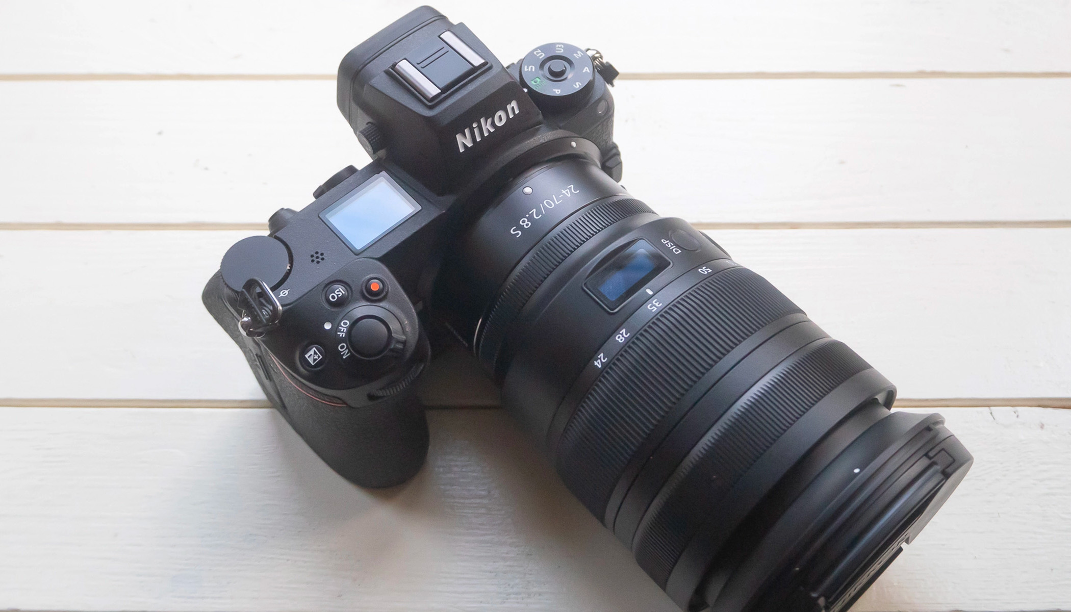 A top view of the Nikon Z6 II equipped with a lens, resting on a wooden table.