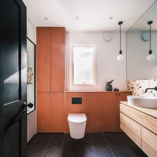A bathroom cabinet that stretches all the way to the ceiling