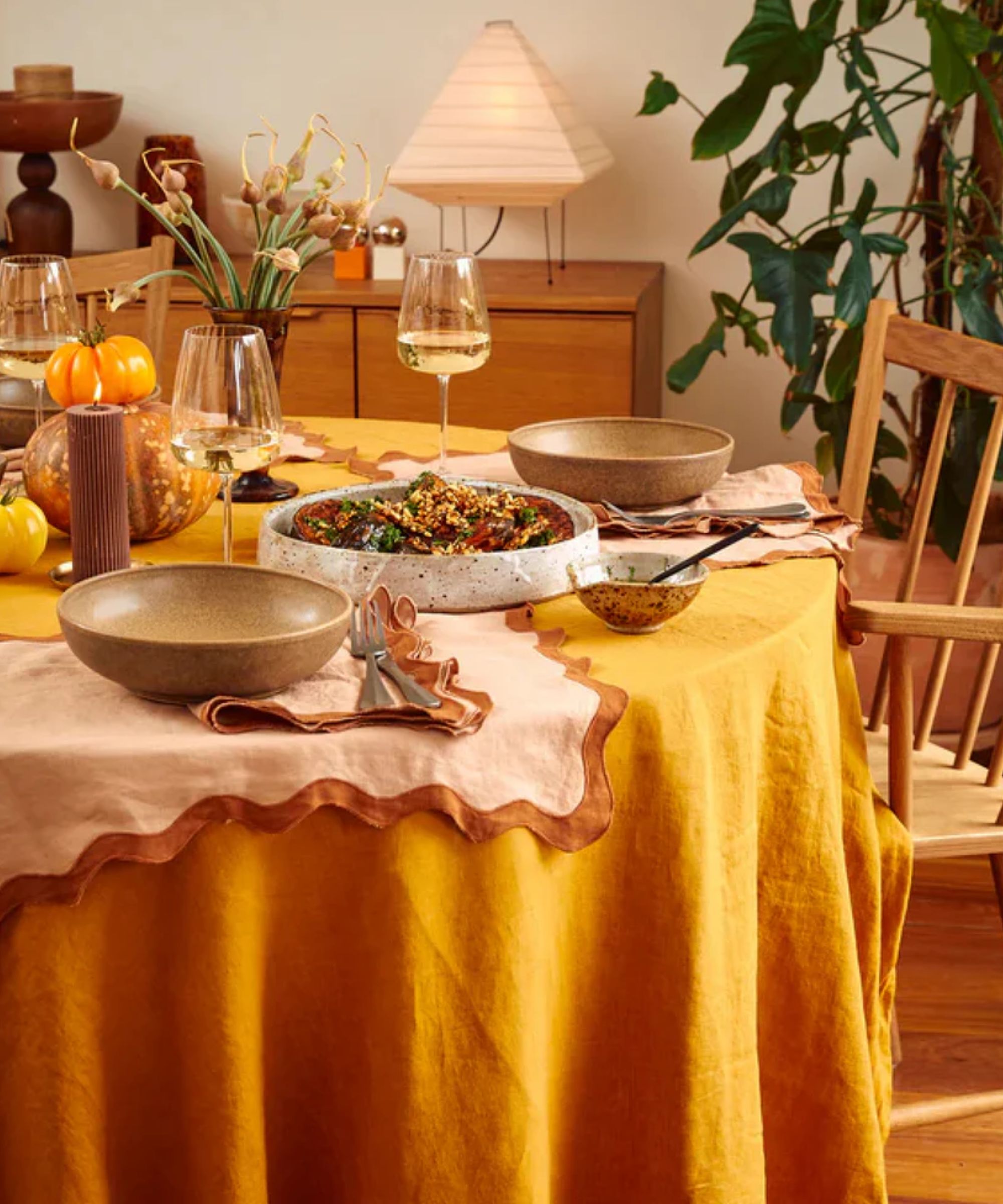 Mustard yellow tablecloth with peach and terracotta scalloped placemats