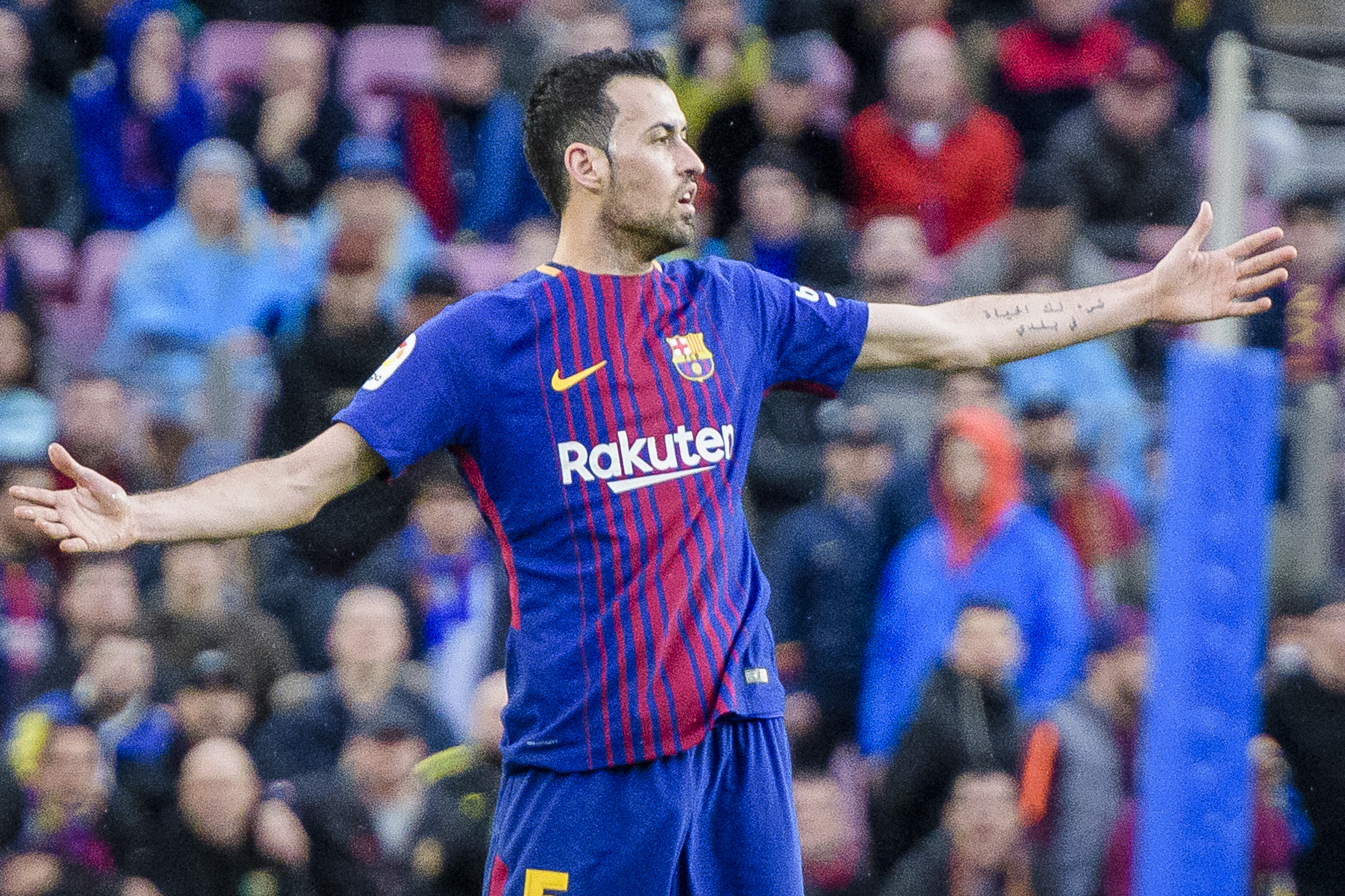 Barcelona midfielder Sergio Busquets gestures during a La Liga match against Atletico Madrid in 2018.