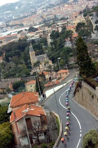 Riders are streaming along the parcours of the Milano-Sanremo (Descending the Poggio).