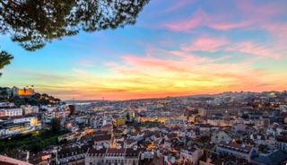 View across Lisbon, Sao Jorge Castle, sunset, Graca viewpoint, Lisbon, Portugal