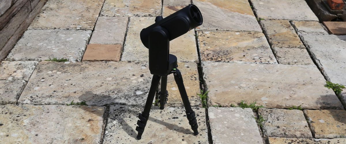 Unistellar Odyssey Pro telescope on a tripod outside on a tiled floor