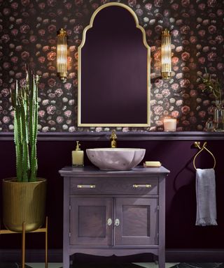 powder room with dark purple patterned wallpaper, purple lower walls and purple vanity