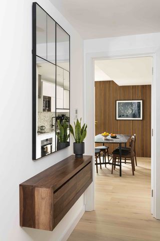 An entryway with a large mirror