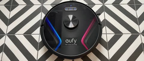 The Eufy RoboVac X8 on a black and white chevron patterned floor