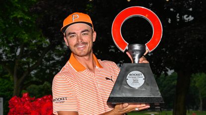 Rickie Fowler with the Rocket Mortgage Classic trophy