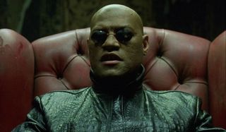 The Matrix Morpheus sits in a chair explaining