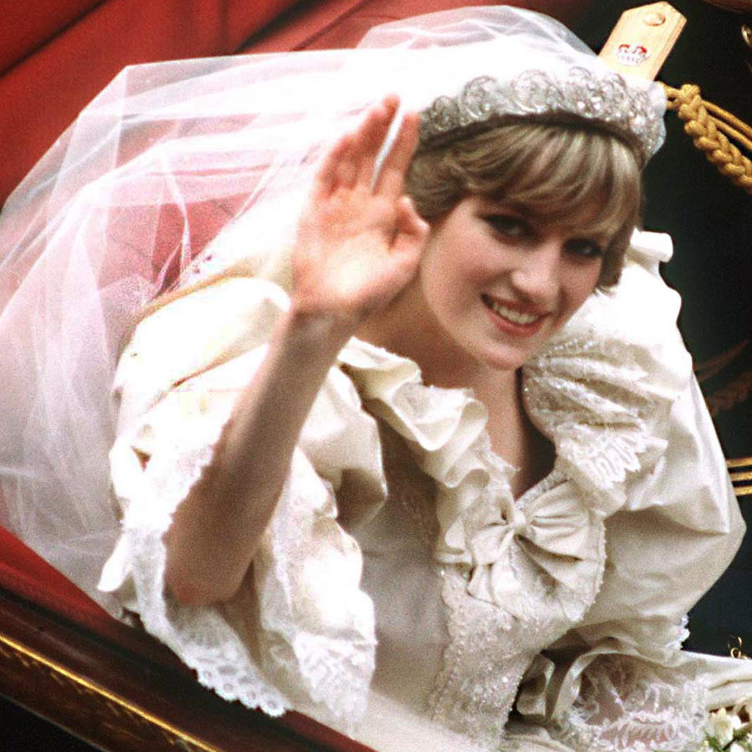 Princess Diana waving in her wedding dress and tiara from a carriage