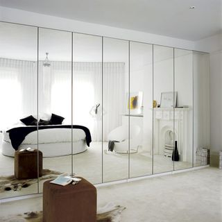 bedroom with white wall and storage cupboard