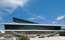 Exterior view of the New Acropolis museum featuring grey concrete and reflective glass design