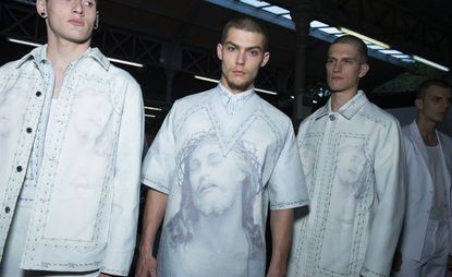Three male models wearing clothing by Givenchy in light shades.