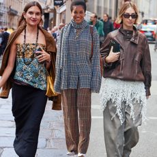 Three women on the streets during paris fashion week.