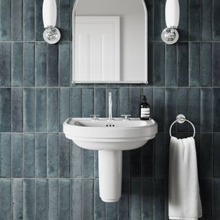 dark blue tiles bathroom with white semi pedestand sink in traditional style