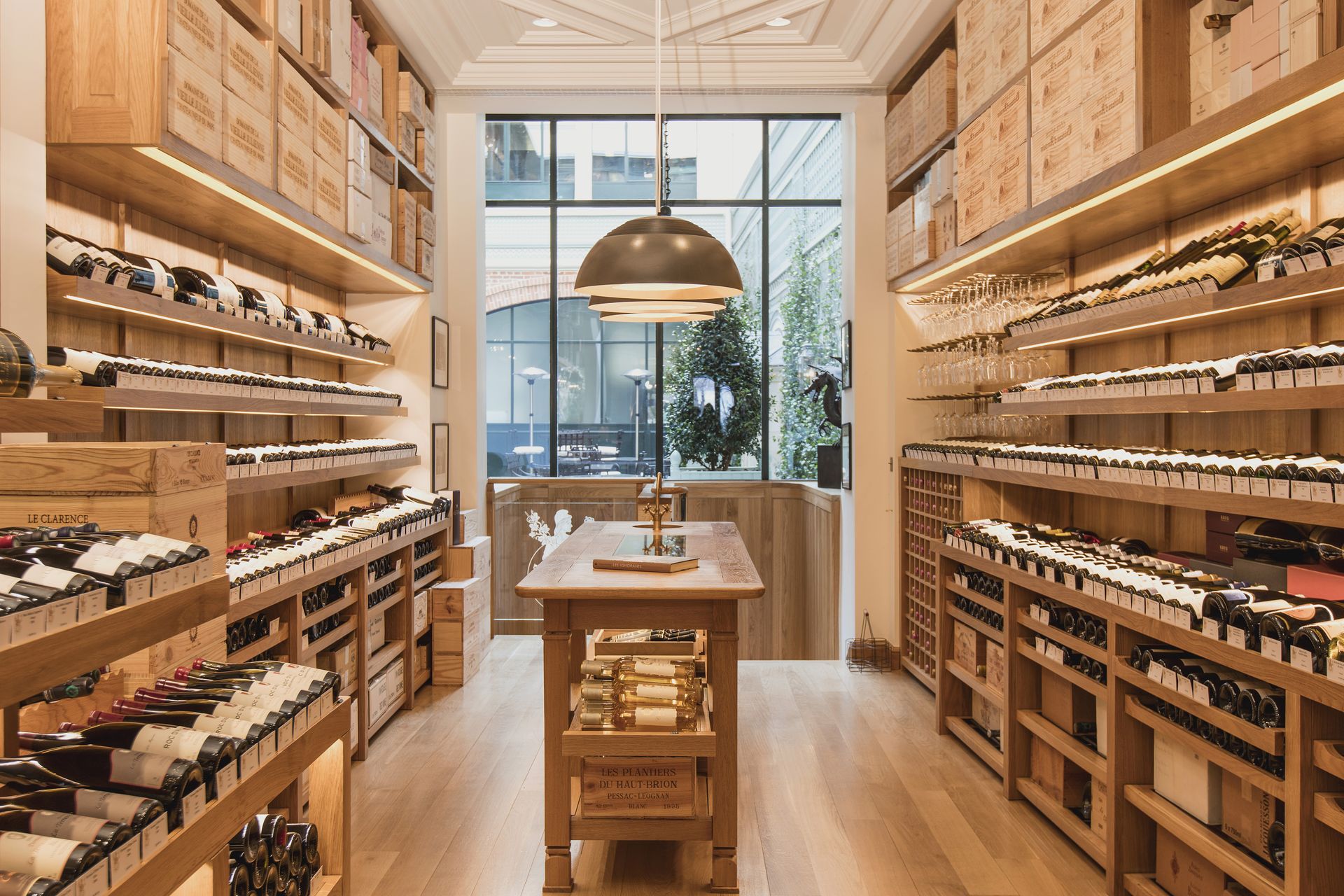 Light wood-lined wine shop inside Le Clarence, Paris
