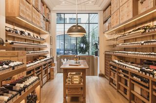 Light wood-lined wine shop inside Le Clarence, Paris