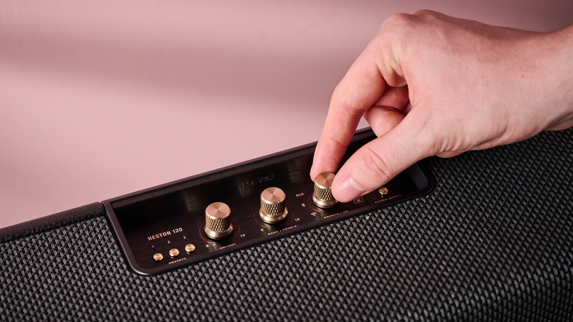 Person twisting knob on the Marshall Heston 120