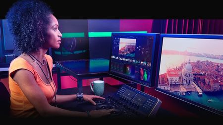 Woman using Da Vinci Resolve on desktop computer