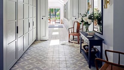 Hall with fitted closet, tile floor, table and chairs