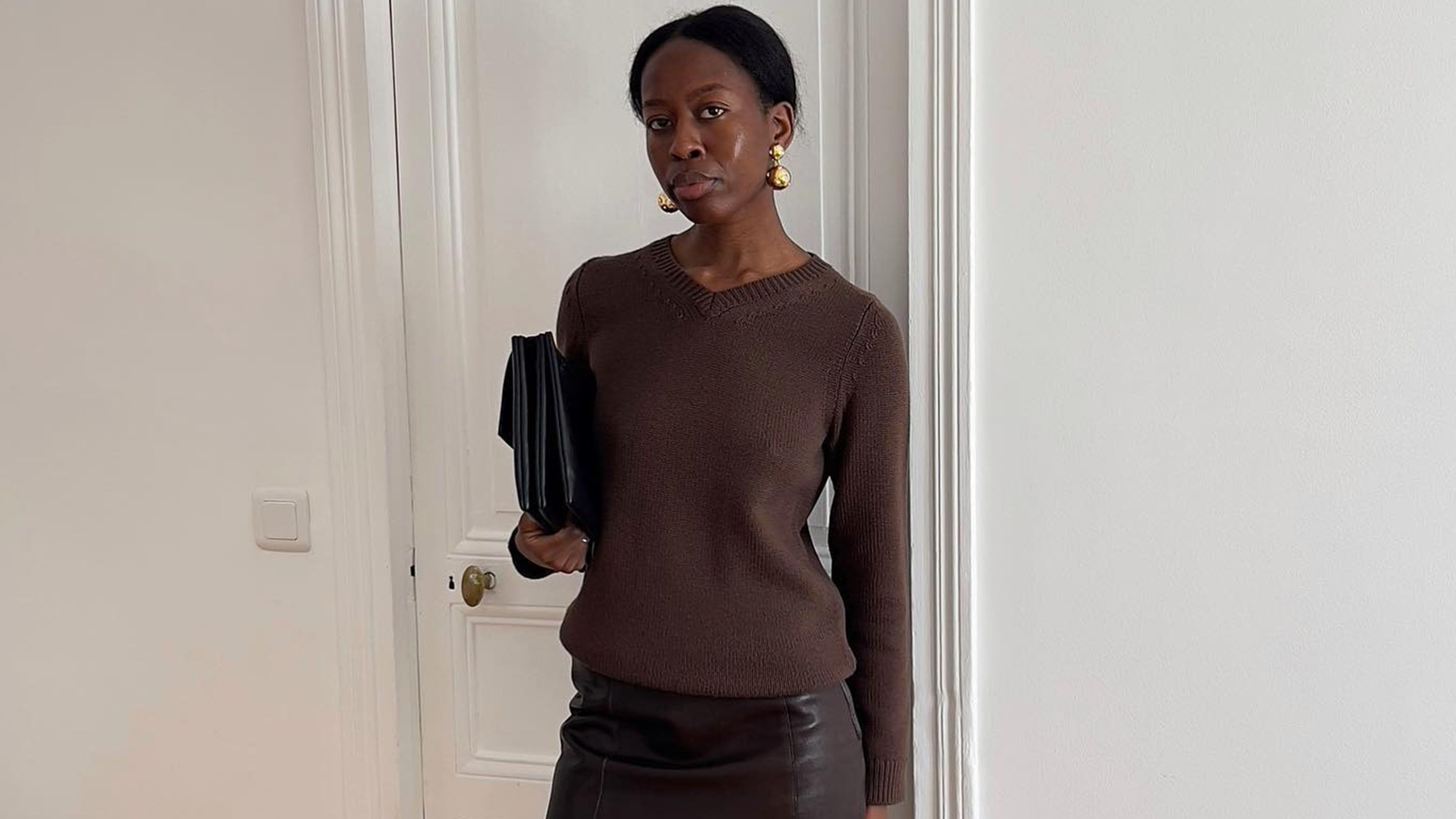 Woman in brown sweater and skirt