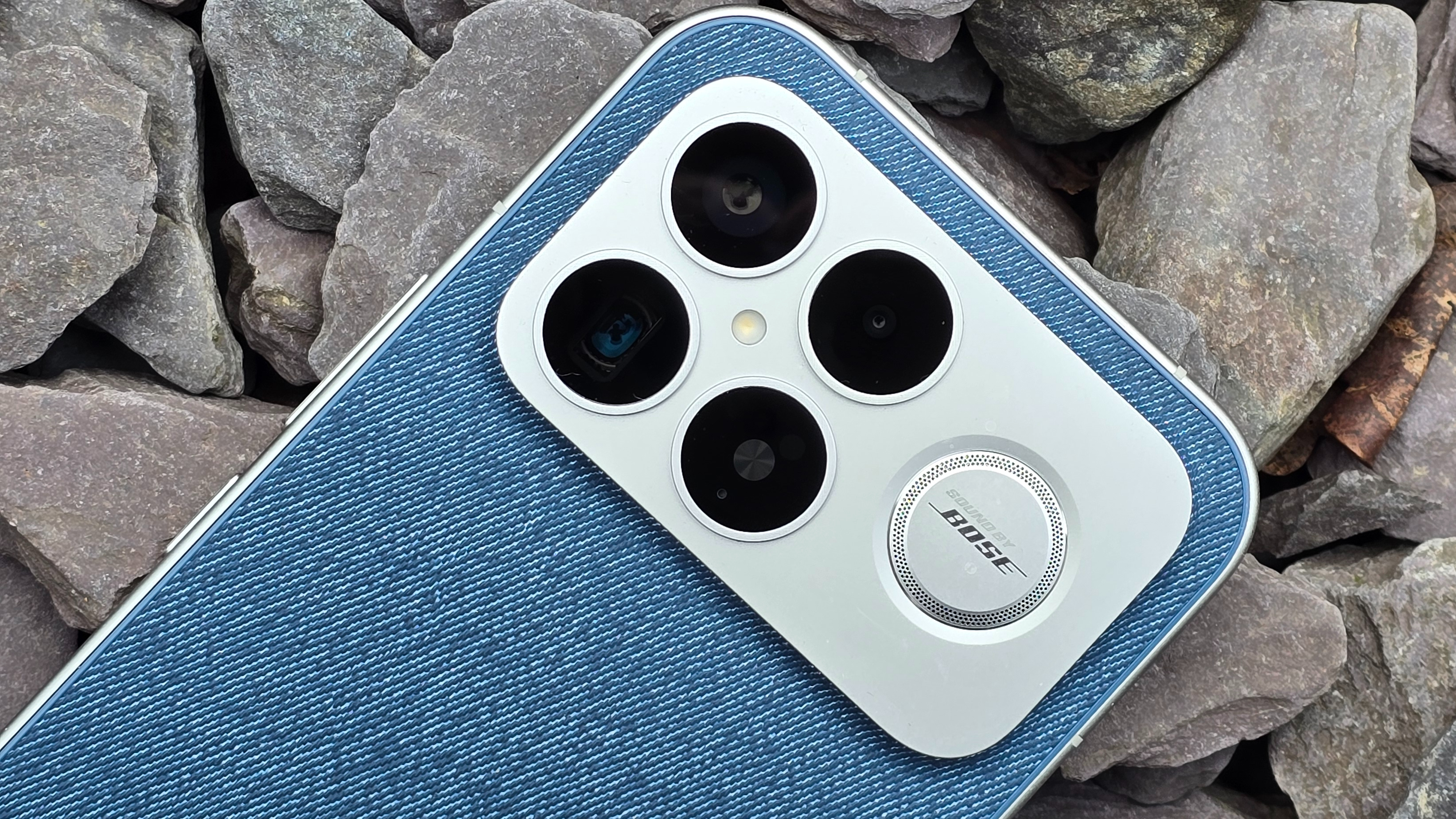The Poco F8 Ultra resting on a pile of stones