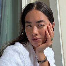 Woman taking selfie wearing white dressing gown