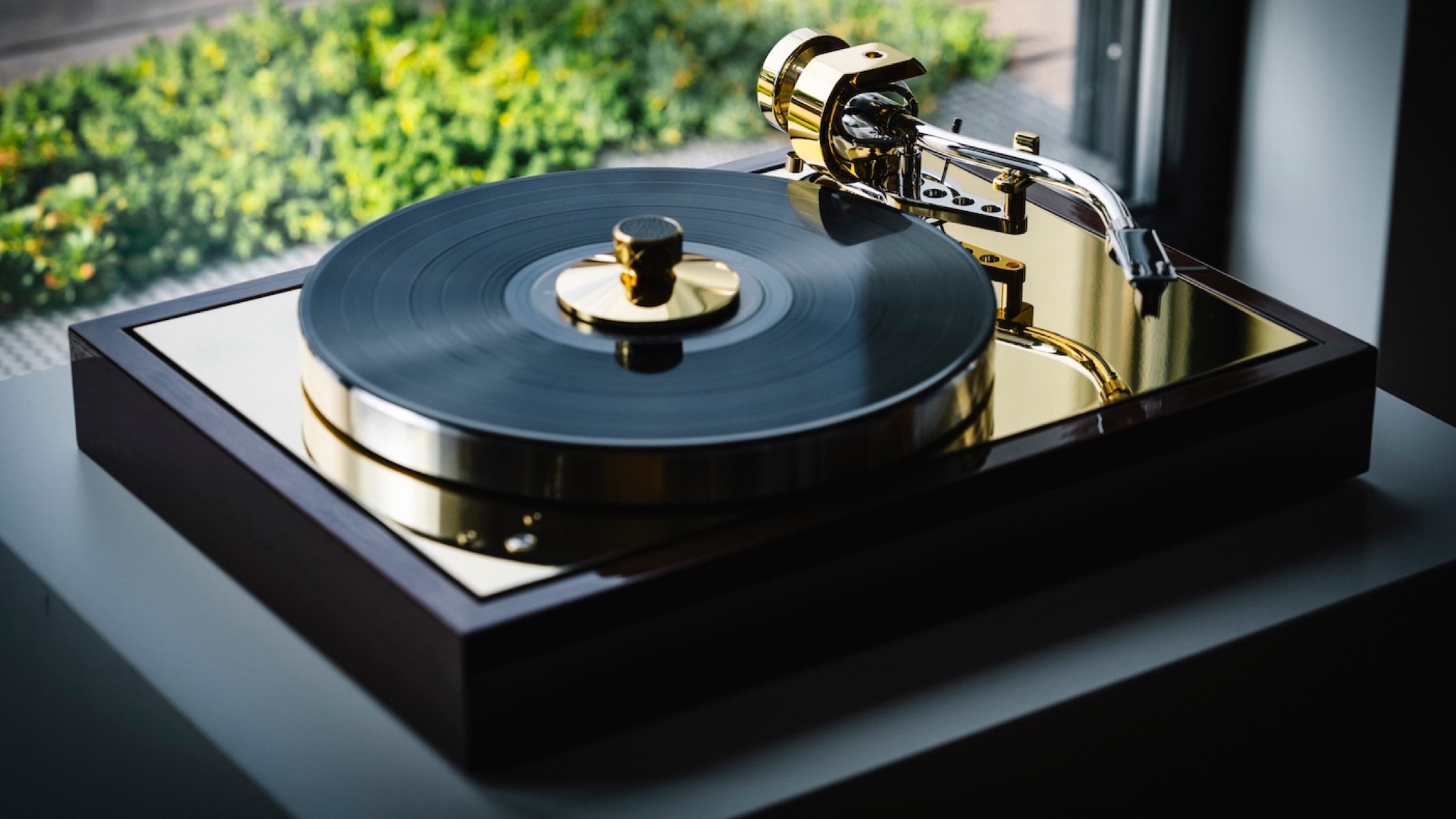 Pro-Ject Classic Reference turntable next to a window opening onto greenery