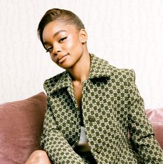 square image of Marsai Martin wearing a green jacket on a blush couch