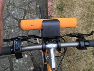 The bracket and battery of the Swytch Bike e-bike conversion kit mounted on a bike
