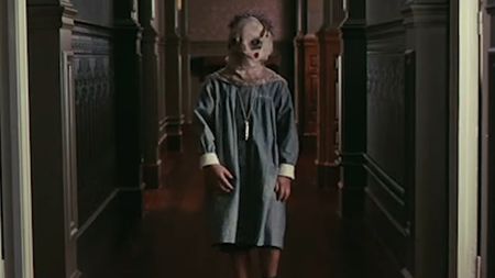 Tomas walking down the hallway with a sack on his head in The Orphanage