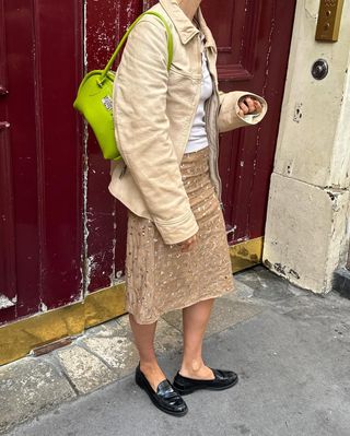 neutral outfit with green purse