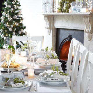 dining room with christmas table setting and 12 piece dinner set
