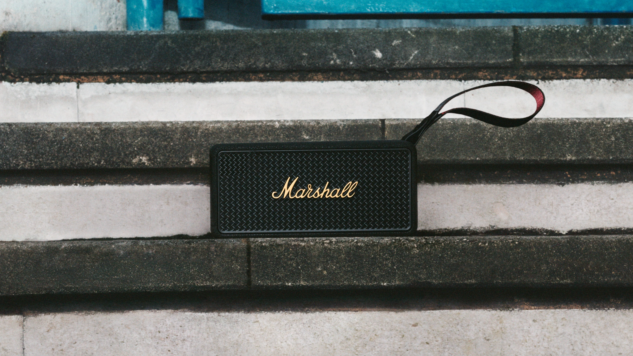 A lifestyle shot of the Marshall Middleton II speaker sitting on some steps