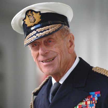 Prince Philip smirks while wearing his military uniform
