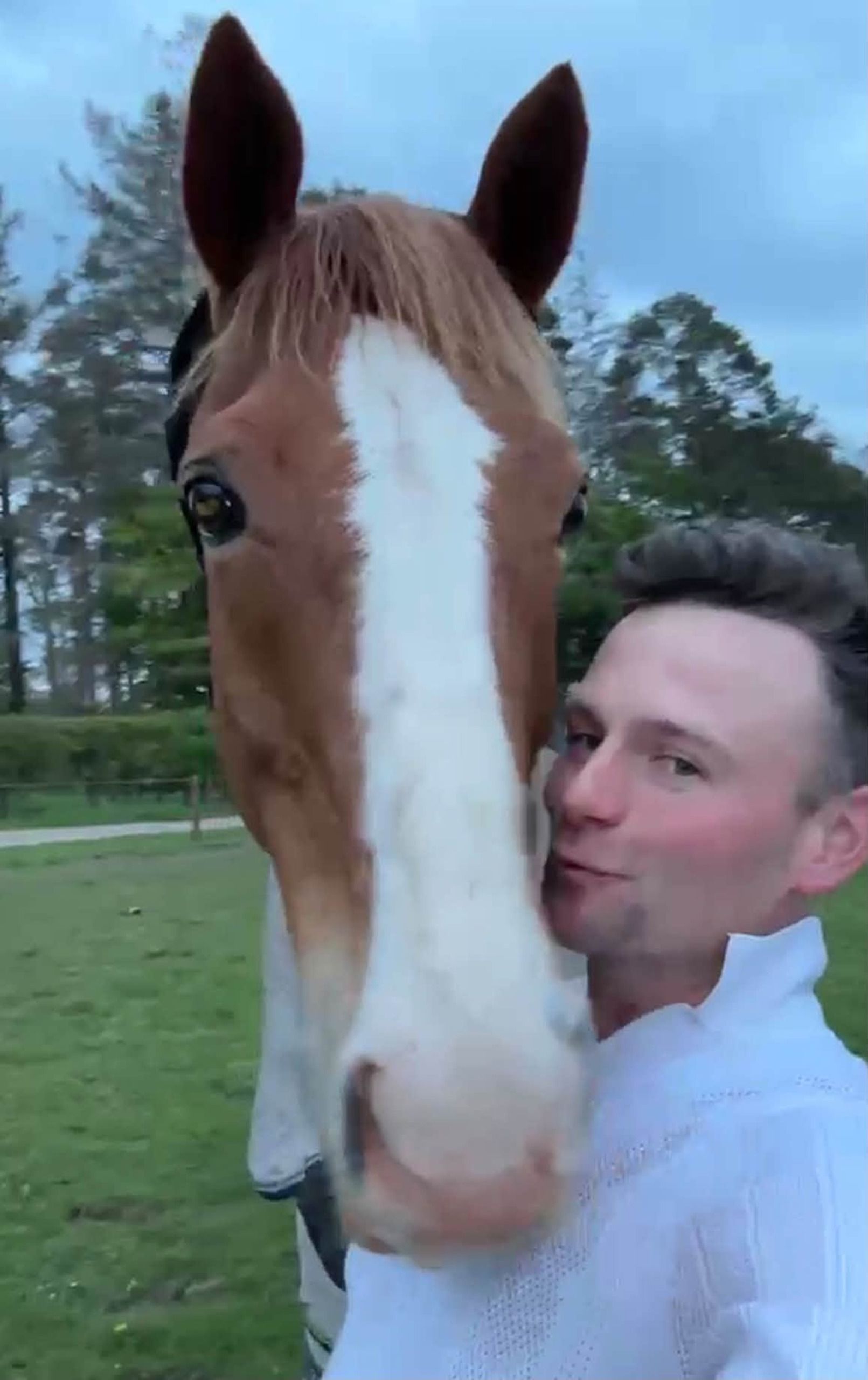 Jack Mantel gives chestnut Night Prowler a kiss in the field